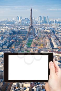 travel concept - tourist photograph Paris skyline with Eiffel Tower afternoon on tablet pc with cut out screen with blank place for advertising logo