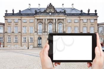 travel concept - tourist photograph Christian VIII's Palace in Copenhagen, Denmark on tablet pc with cut out screen with blank place for advertising logo