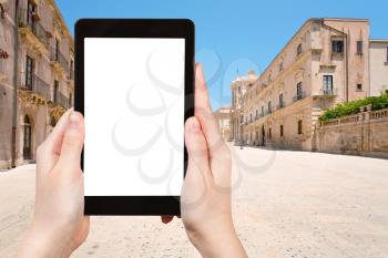 travel concept - tourist photograph Piazza di Duomo in Syracuse, Sicily, Italy on tablet pc with cut out screen with blank place for advertising logo
