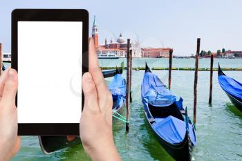 travel concept - tourist photograph gondolas on San Marco Canal in Venice, Italy on tablet pc with cut out screen with blank place for advertising logo