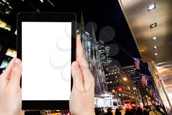 travel concept - tourist photograph New York avenue in night on tablet pc with cut out screen with blank place for advertising logo