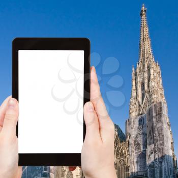 travel concept - tourist photograph St Stephan Cathedral, Vienna, Austria on tablet pc with cut out screen with blank place for advertising logo