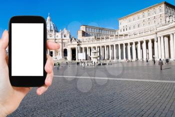 travel concept - tourist photograph St.Peter Square and St Peter Basilica in Vatican, Rome, Italy on smartphone with cut out screen with blank place for advertising logo