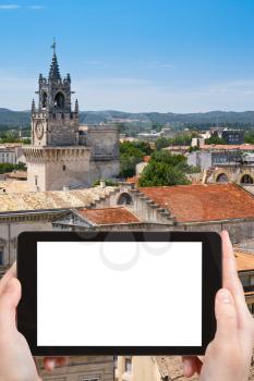 travel concept - tourist photograph medieval town Avignon, France on tablet pc with cut out screen with blank place for advertising logo