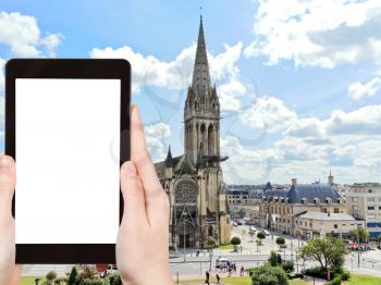 travel concept - tourist photograph Church of Saint-Pierre in Caen city, France on tablet pc with cut out screen with blank place for advertising logo