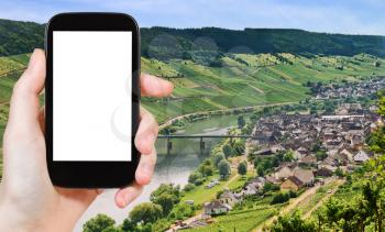 travel concept - tourist photograph Town Zell and Moselle river, Germany in summer day on tablet pc with cut out screen with blank place for advertising logo