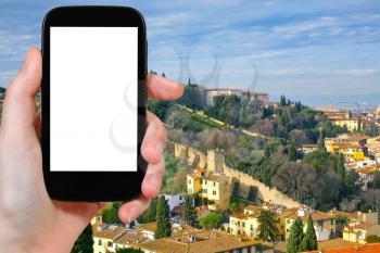 travel concept - tourist photograph old city wall in Florence, Tuscany, Italy on smartphone with cut out screen with blank place for advertising logo