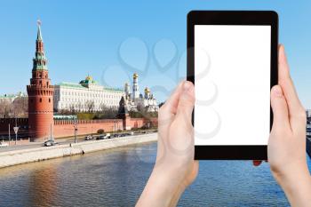 travel concept - tourist photograph Moscow cityscape with Kremlin, embankments, Moskva river in spring day on tablet pc with cut out screen with blank place for advertising logo