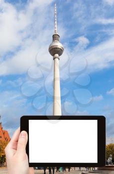 travel concept - tourist photograph Fernsehturm TV Tower in Berlin, Germany on tablet pc with cut out screen with blank place for advertising logo