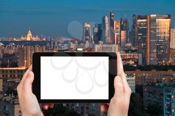 travel concept - tourist photograph late summer blue twilight over Moscow city, Russia on tablet pc with cut out screen with blank place for advertising logo