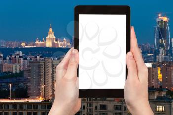 travel concept - tourist photograph Moscow city skyline at dusk in summer night , Russia on tablet pc with cut out screen with blank place for advertising logo