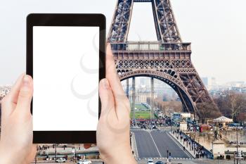 travel concept - tourist photograph Champ de Mars, Pont d Iena and Eiffel Tower in Paris, France on tablet pc with cut out screen with blank place for advertising logo