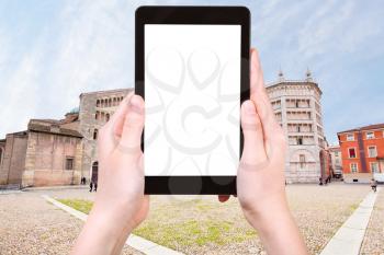 travel concept - tourist photograph Cathedral, the Baptistery on Piazza del Duomo, Parma, Italy on tablet pc with cut out screen with blank place for advertising logo