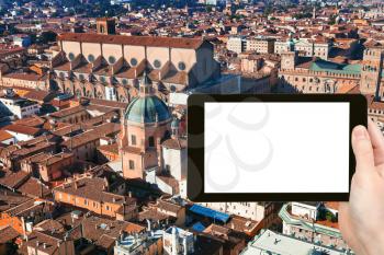 travel concept - tourist photograph above view of The Basilica of San Petronio in Bologna, Italy on tablet pc with cut out screen with blank place for advertising logo