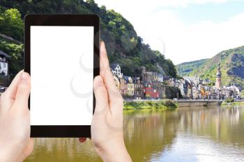 travel concept - tourist photograph waterfront in Cochem town on Moselle river, Germany on tablet pc with cut out screen with blank place for advertising logo