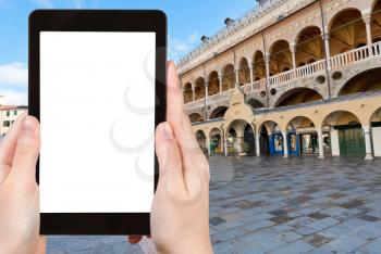 travel concept - tourist photograph Palazzo della Ragione on Piazza delle Erbe in Padua, Italy on tablet pc with cut out screen with blank place for advertising logo
