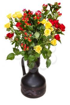 yellow, red roses and hypericum flowers in ceramic vase on white background