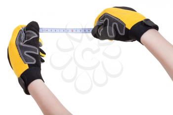 worker hands in protective glowes with measuring tape isolated on white background