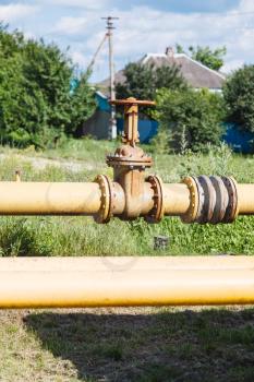 country gasification - valve on gas pipeline in village in summer day