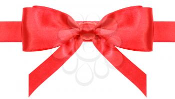 symmetric red satin bow with vertically cut ends on ribbon close up isolated on white background
