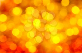 abstract blurred background - yellow and red shimmering Xmas lights of garlands on Christmas tree
