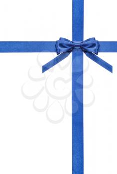 one blue satin bow in upper right corner and two intersecting ribbons isolated on vertical white background