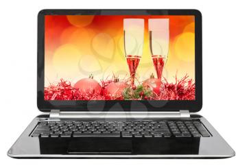 Christmas still life with red ball and glasses on screen of laptop isolated on white background
