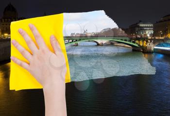 travel concept - hand deletes night view of Paris by yellow cloth from image and daily cityscape is appearing