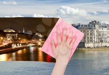 travel concept - hand deletes night view of Paris by pink cloth from image and day cityscape is appearing