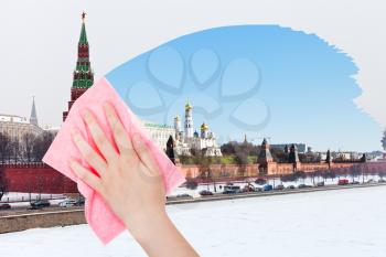 travel concept - hand deletes winter view of Moscow by pink cloth from image and summer cityscape is appearing
