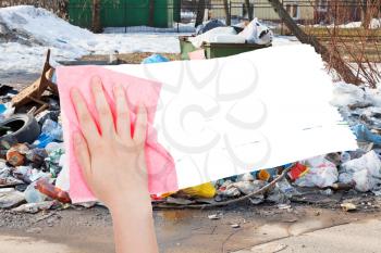 ecology concept - hand deletes urban dumpster by pink rag from image and white empty copy space are appearing