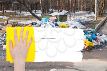 ecology concept - hand deletes outdoor trash by yellow rag from image and white empty copy space are appearing