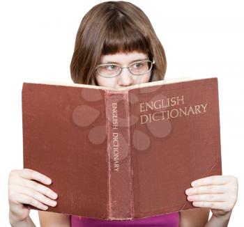 girl with glasses reads big English Dictionary book isolated on white background