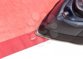 clothing iron ironing red shirt close up isolated on white background