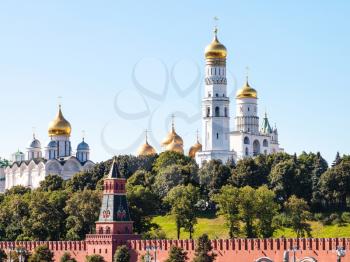 Moscow cityscape - Ivan the Great Bell Tower with Assumption Belfry and The Cathedral of the Archangel on green hill in Moscow Kremlin, Russia