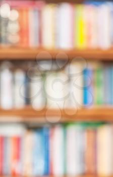 defocused background from book shelves with many books