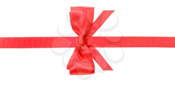 real red satin bow with vertically cut ends on narrow ribbon isolated on white background