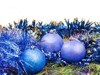 blue Christmas decorations on green spruce tree branch isolated on white background