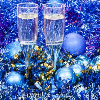 Christmas still life - two glasses of sparkling wine in blue Xmas decorations
