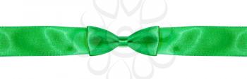symmetrical bow-knot on narrow green silk ribbon isolated on white background