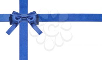 one blue satin bow in upper left corner and two intersecting ribbons isolated on horizontal white background