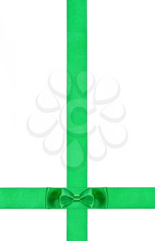 little double green bow knot on two crossing silk ribbons isolated on white background