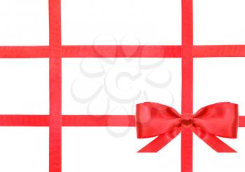 one red satin bow in lower right corner and four intersecting ribbons isolated on horizontal white background