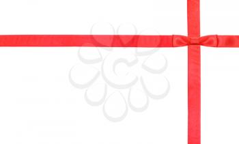 one red satin bow knot upper right corner and two intersecting ribbons isolated on horizontal white background