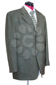 business suit on tailor mannequin - green tweed jacket with shirt and tie isolated on white background