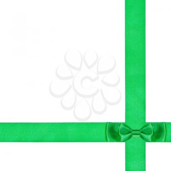 double green bow knot on two crossing silk ribbons isolated on white background