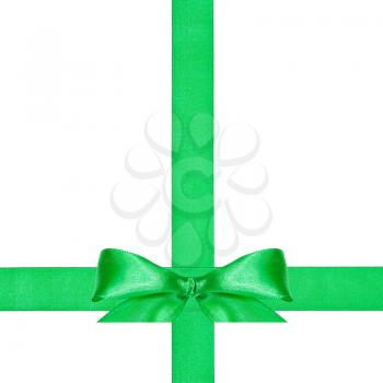 one big green bow knot on two crossing satin ribbons isolated on white background