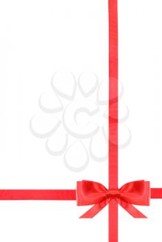 one red satin bow in lower right corner and two intersecting ribbons isolated on vertical white background