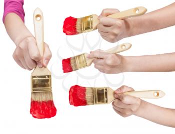 set of painter hands with flat paint brushes with red painted tips isolated on white background
