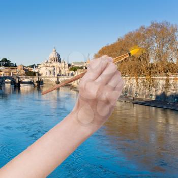 travel concept - hand with paintbrush paints trees in yellow colour in Rome, Italy